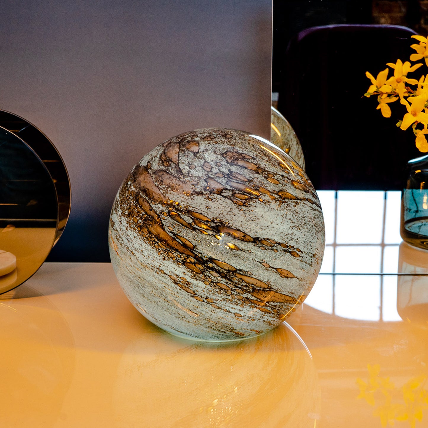 Round glass table light with a design based on the planet mercury lifestyle