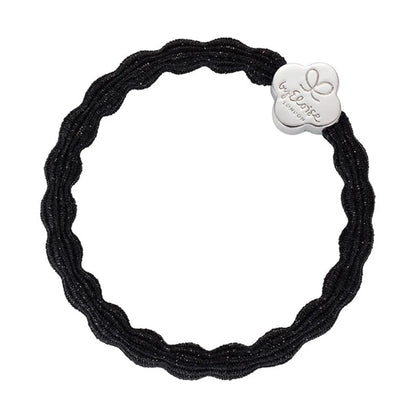 Metallic black coloured bubble shaped hair tie with silver quatrefoil charm