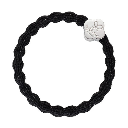 Metallic black coloured bubble shaped hair tie with silver quatrefoil charm