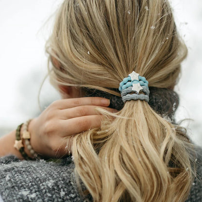 Model wearing elastic bubble hair band in metallic silver with silver star charm