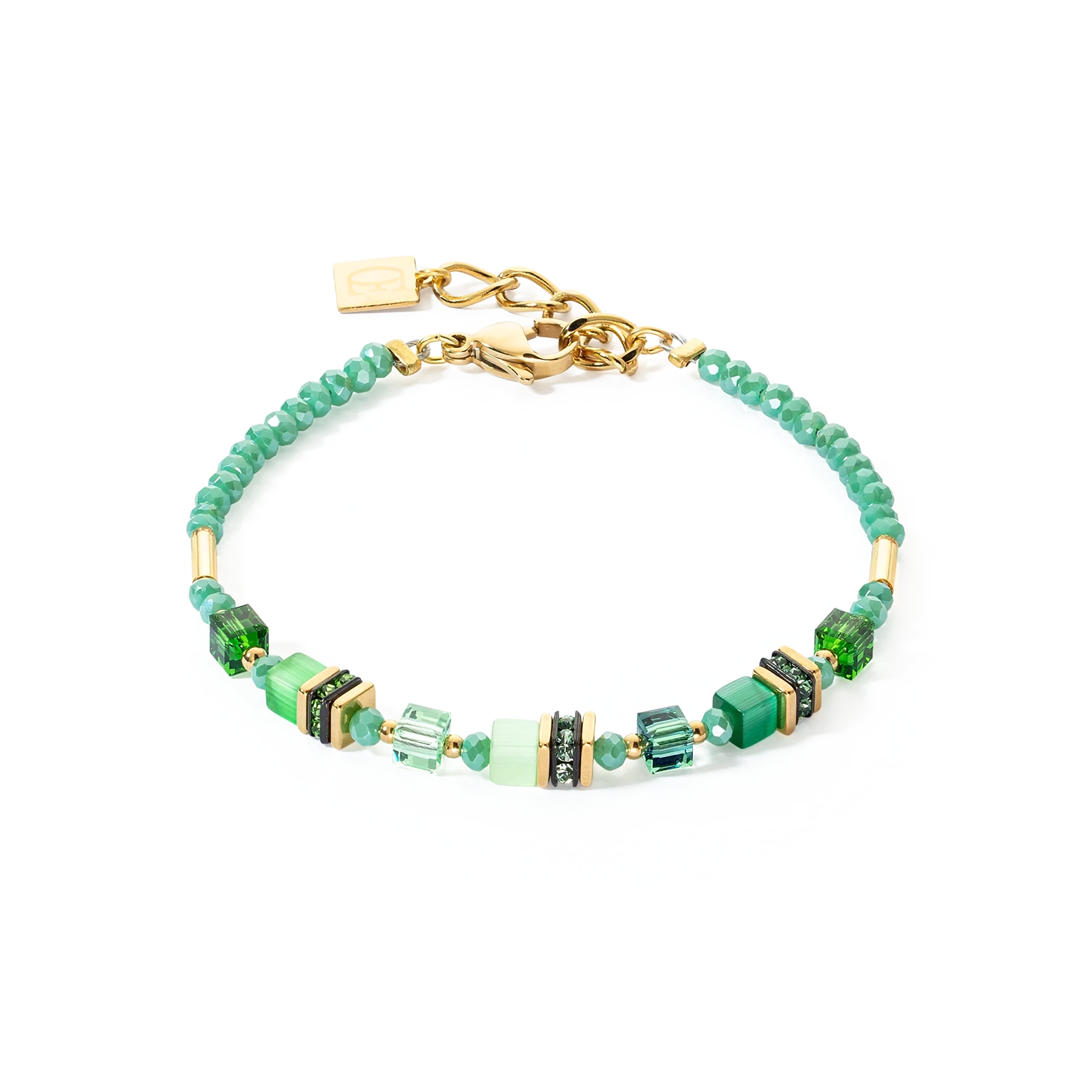 A gold bracelet with bright green stones