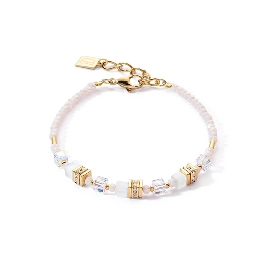 A bracelet with white and gold mini cube shaped stones and cut glass beads