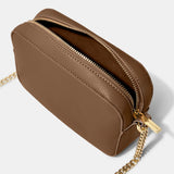 An open light brown camera bag with gold chain detail on the strap, textured leather and a zip top