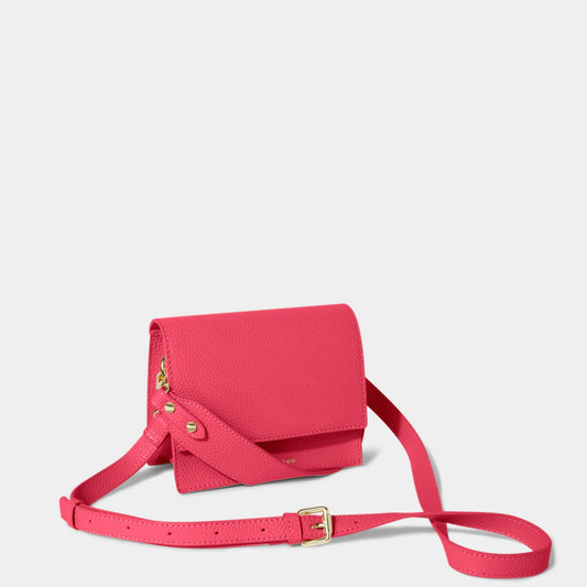 Pink crossbody bag with carry handle and belt buckle style shoulder strap