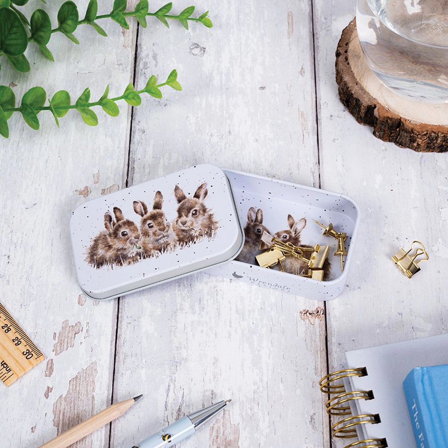 Mini tin fully illustrated with artwork of rabbits by Hannah Dale lifestyle