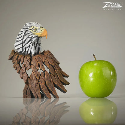 Brown and white painted American Eagle bust and wing sculpture size comparison to apple