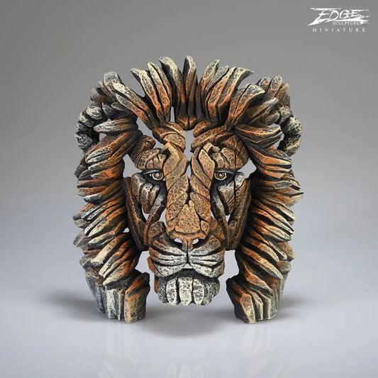 A textured and painted lion head bust sculpture