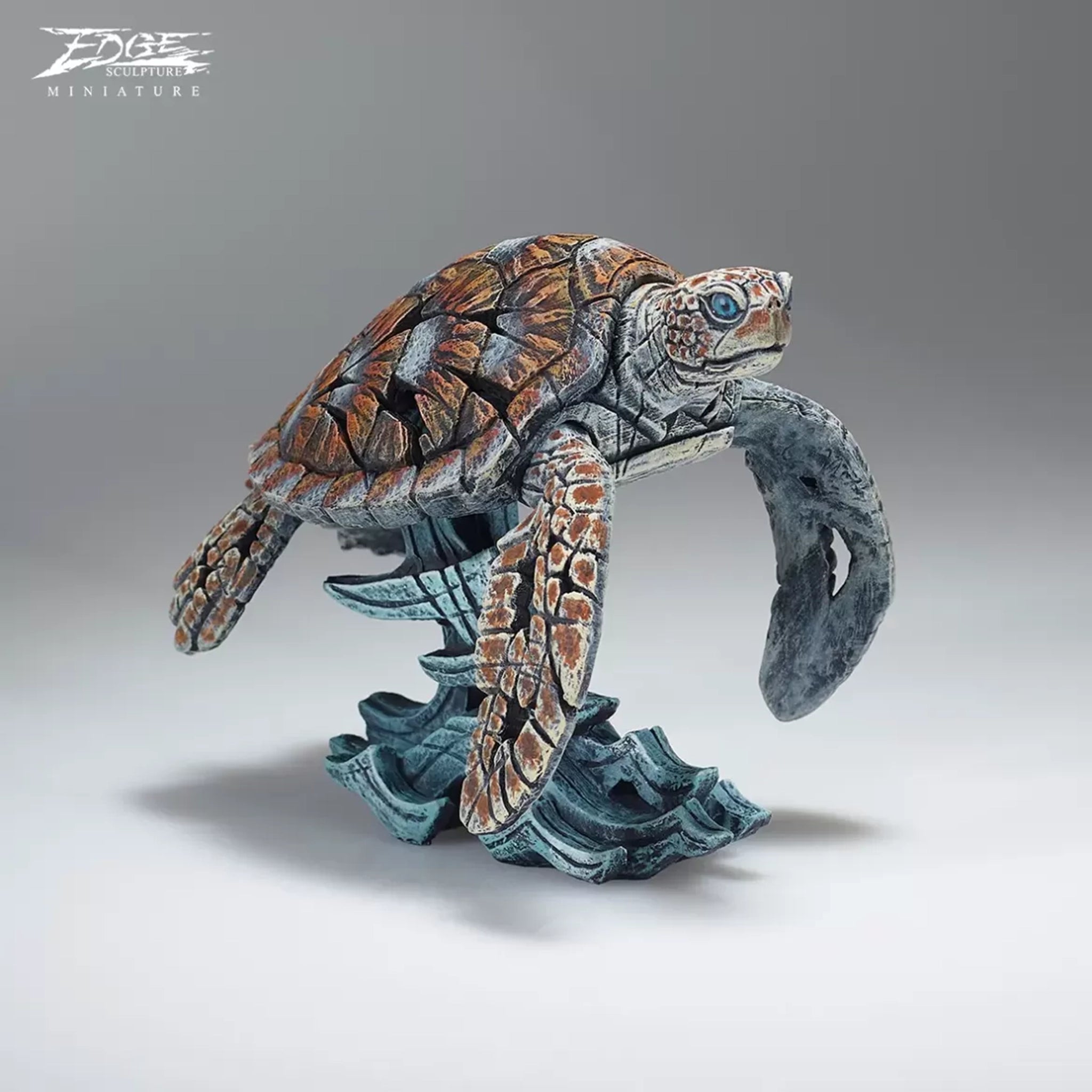 A textured and painted sea turtle surfing waves sculpture front view