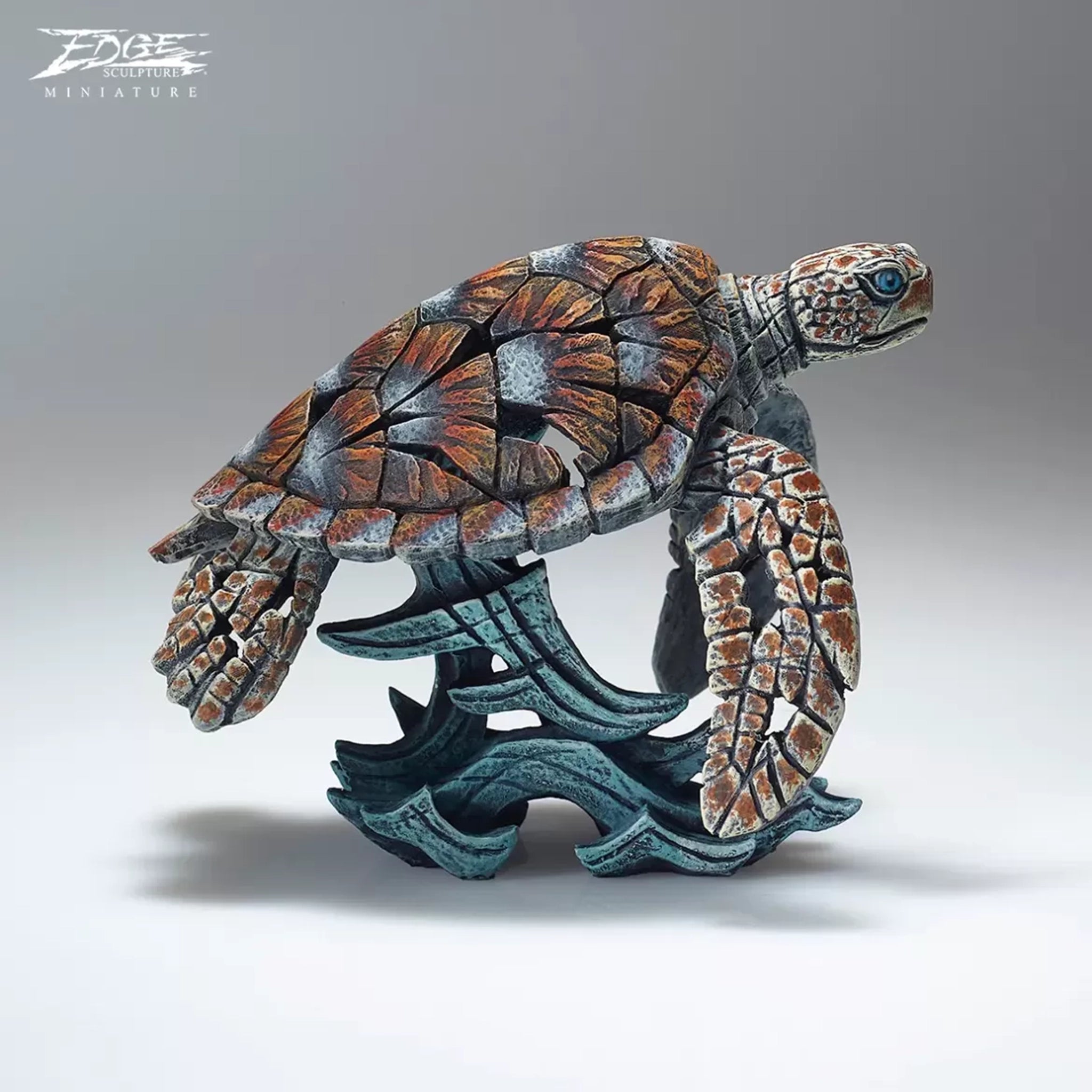 A textured and painted sea turtle surfing waves sculpture side view