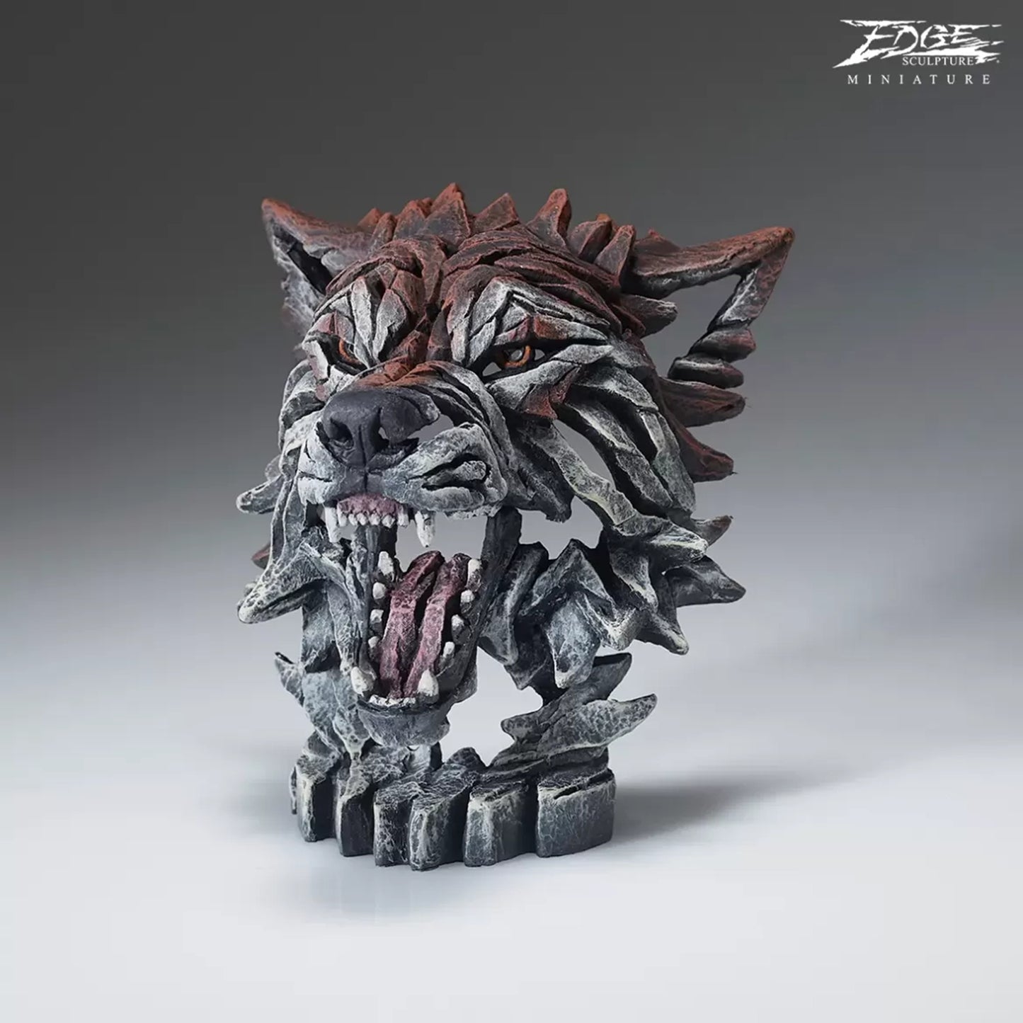 A textured and painted wolf head bust sculpture side view