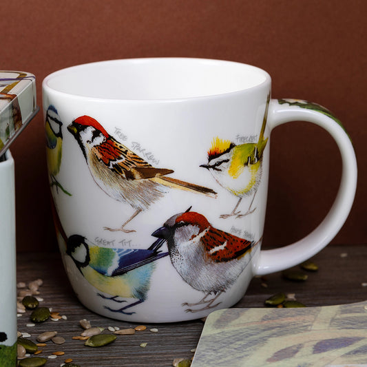 A close up of a white mug featuring illustrations of various British garden birds