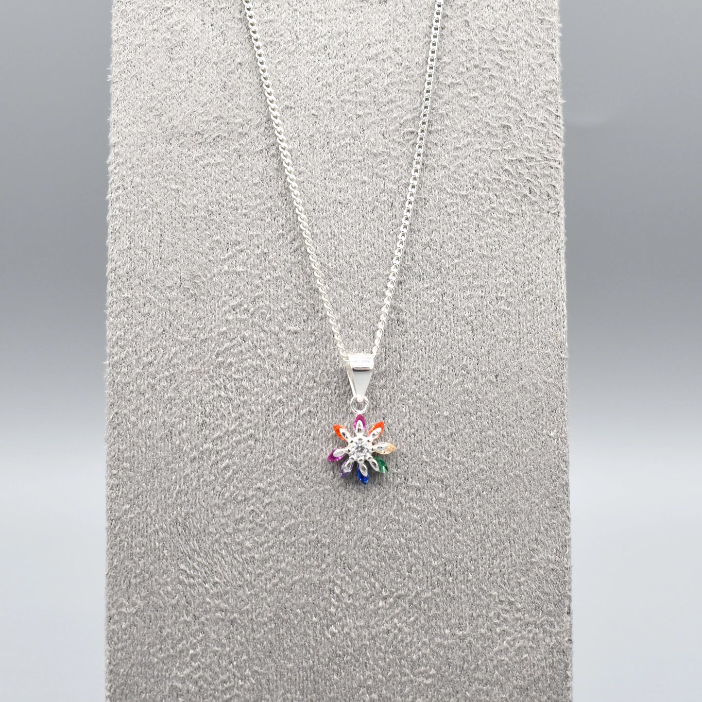Silver star flower shaped pendant with multicolour CZ stone petals