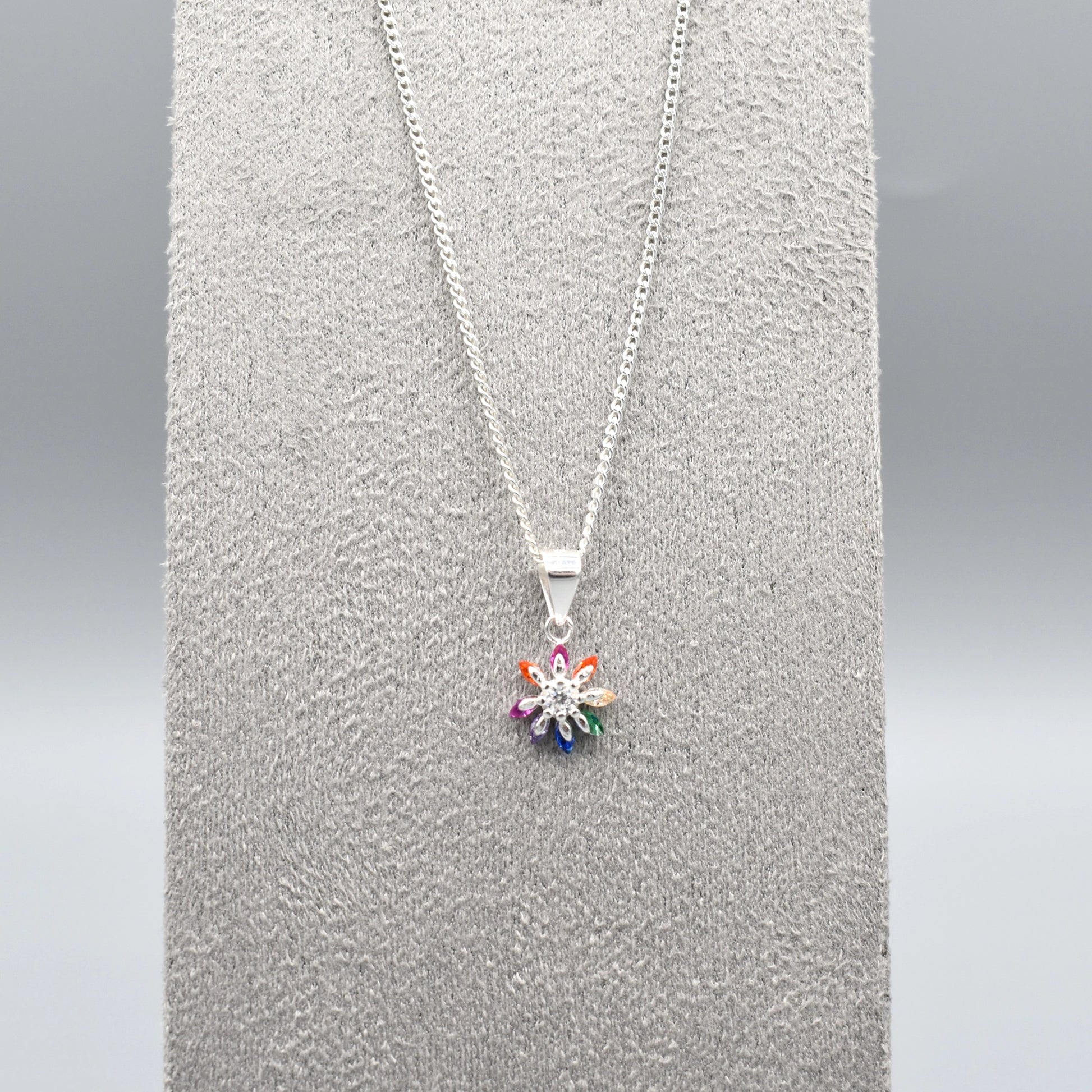 Silver star flower shaped pendant with multicolour CZ stone petals