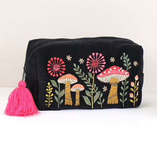 Black velvet makeup bag embroidered with mushrooms and finished with a pink tassel