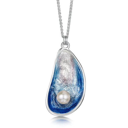 A large silver pendant in the shape of a mussel with gradient blue enamel and a pearl on a chain
