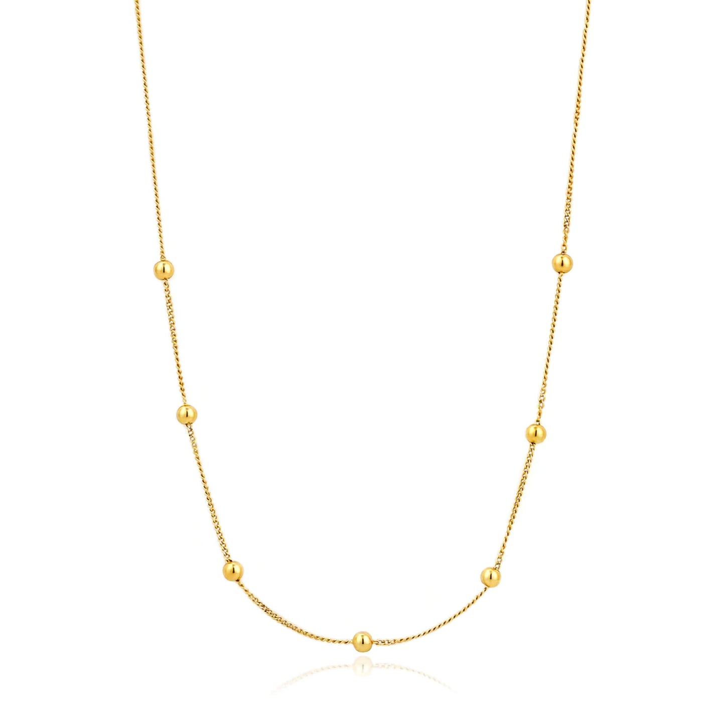 A gold chain necklae featuring 7 gold ball details spaced symmetrically