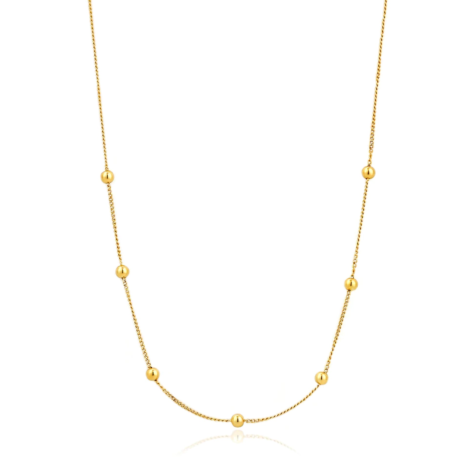 A gold chain necklae featuring 7 gold ball details spaced symmetrically