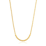 A gold chain necklace featuring a bar of linked gold balls