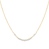 A simple gold chain necklace with CZ stones in a symmetrical arc