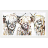 A framed print of three Highland Cows