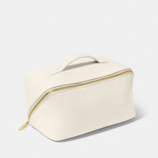 An off-white makeup and wash bag with a gold zip in faux leather