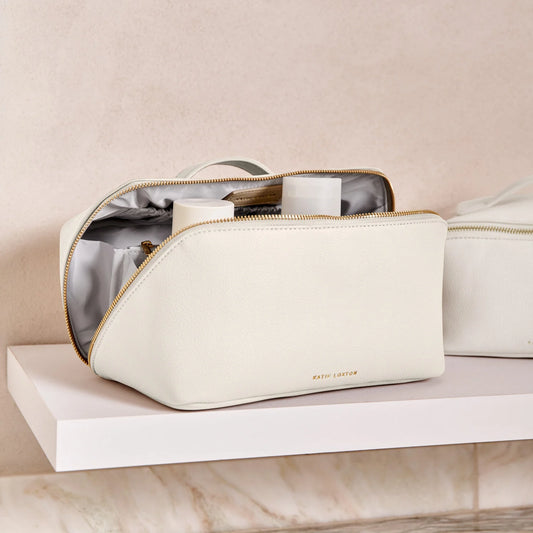 An off-white makeup and wash bag with a gold zip in faux leather lifestyle