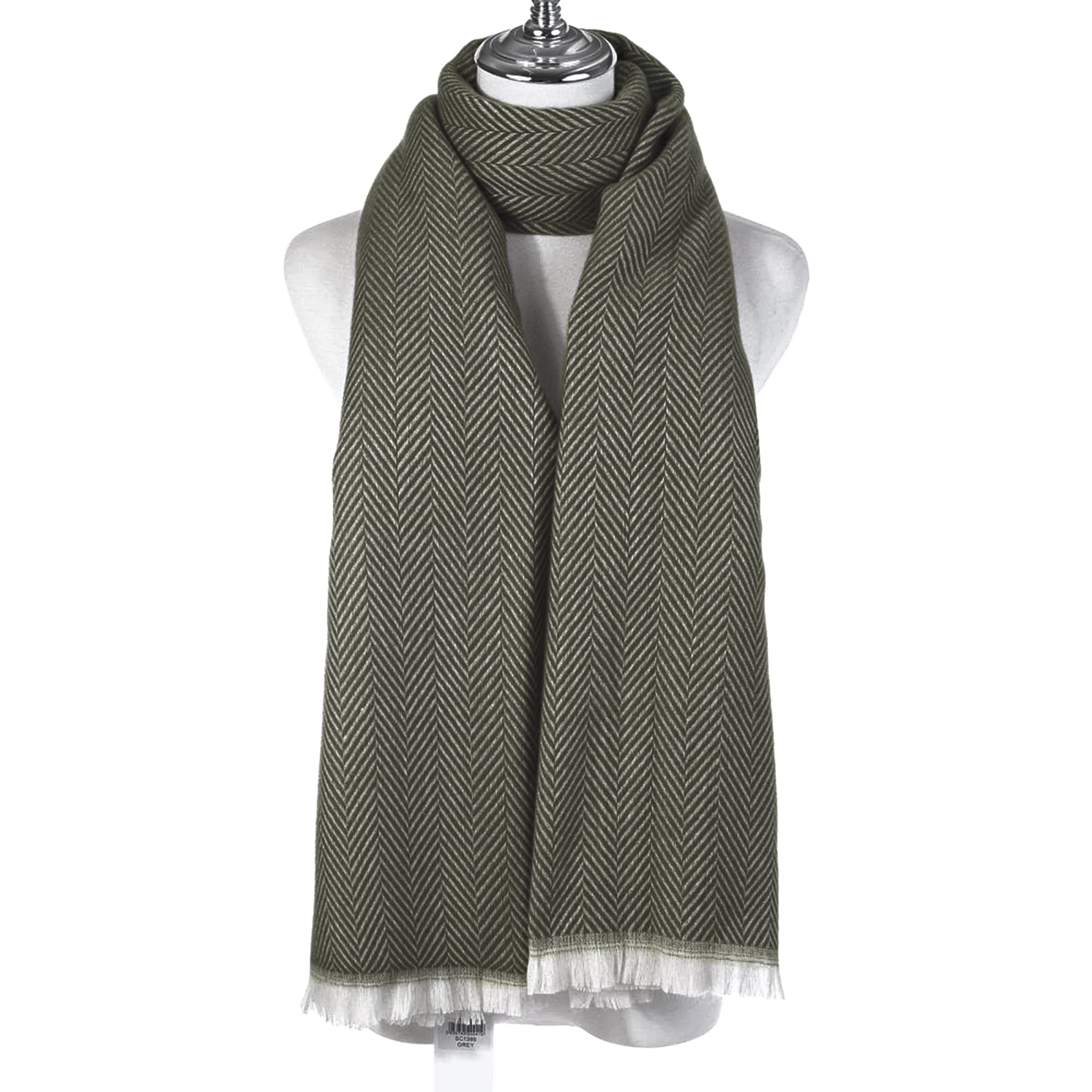 An olive chevron patterned scarf with a white fringe