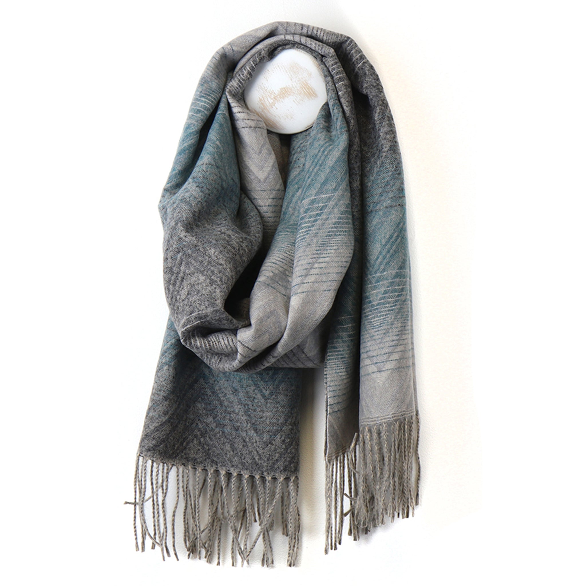 A blue to grey ombre scarf with subtle stripe and zigzag overlay details 