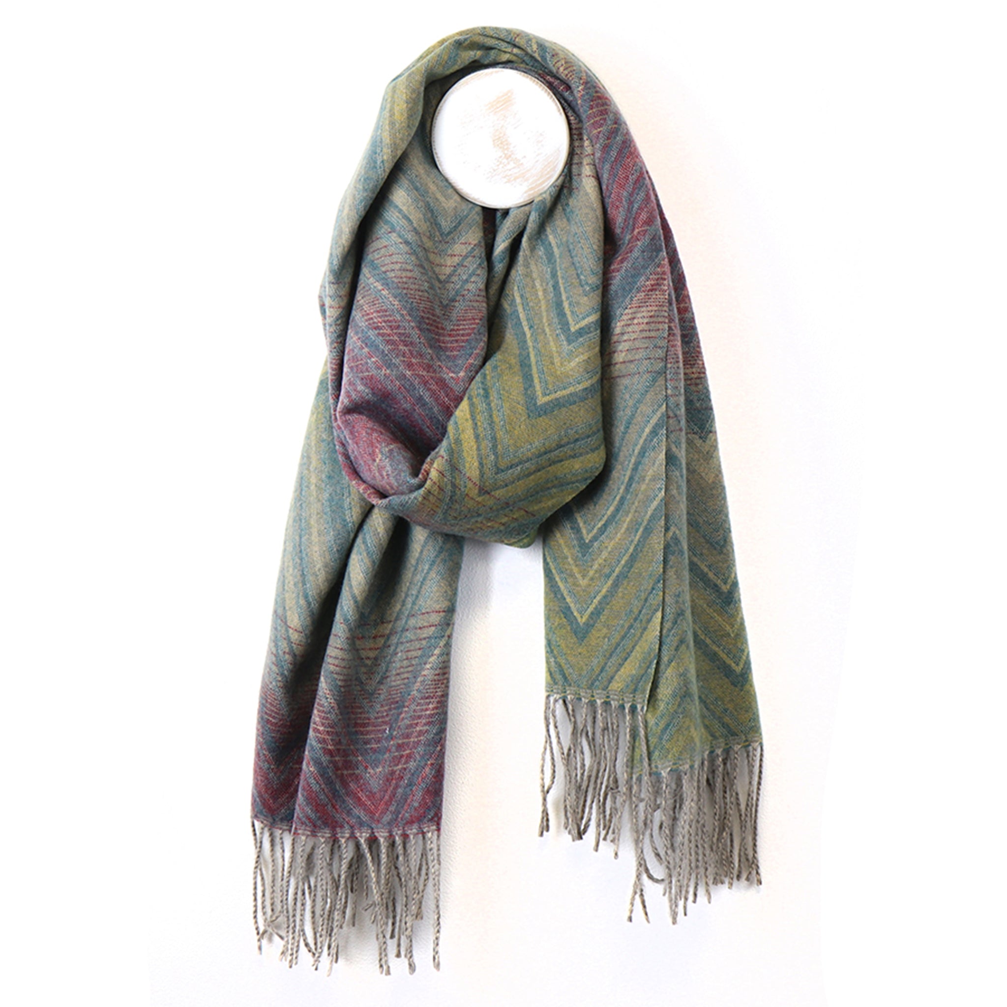 An ombre green to purple scarf with overlayed stripes and zigzag patterns