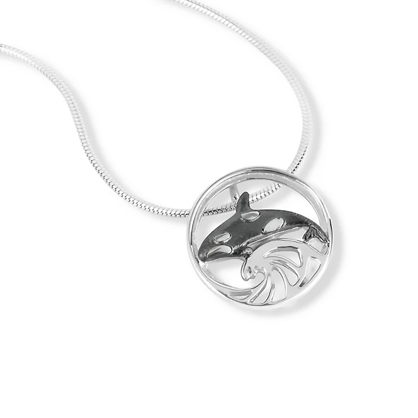 Silver necklace with round pendant that features a wave design and an oxidised Orca in the centre