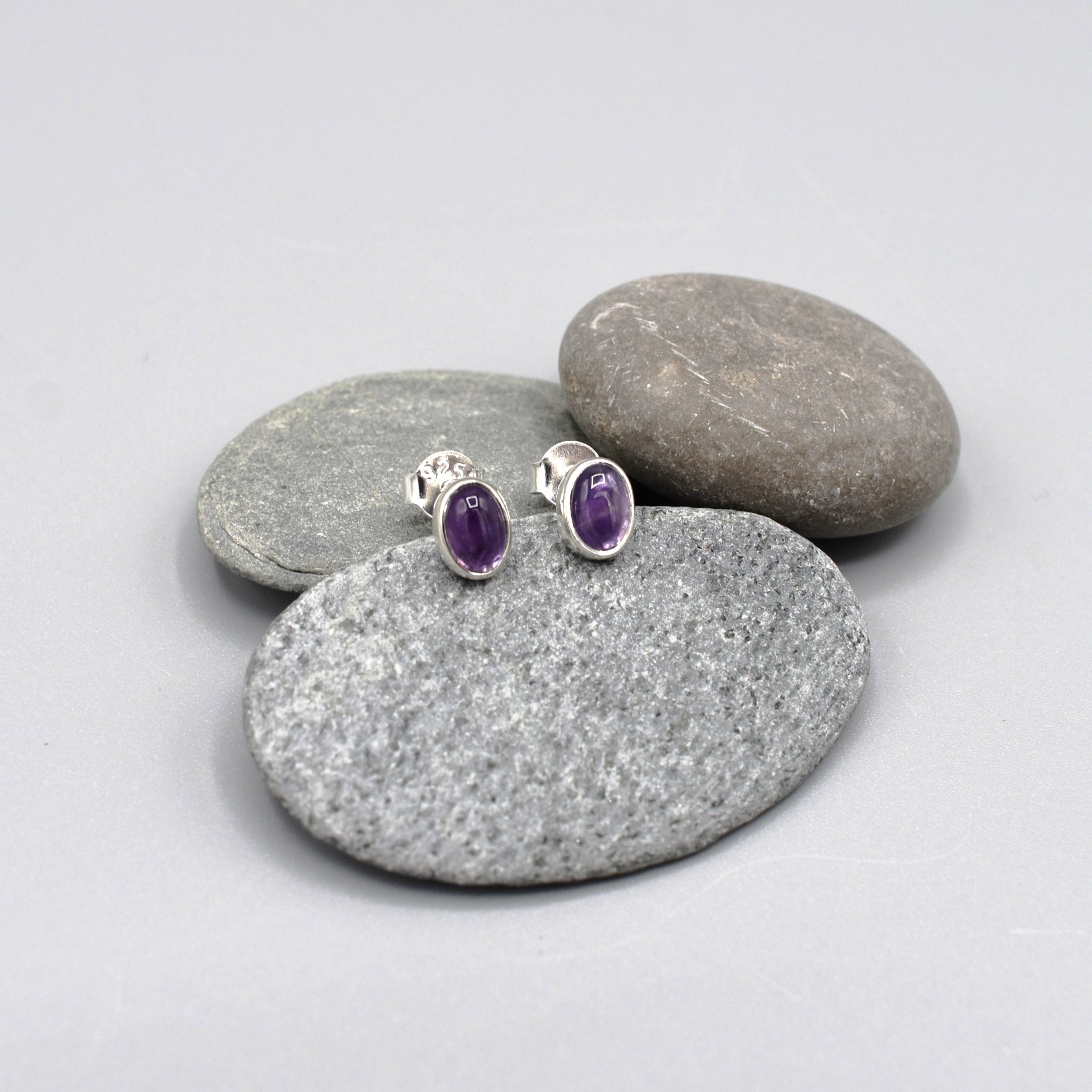 A pair of silver oval amethyst stud earrings