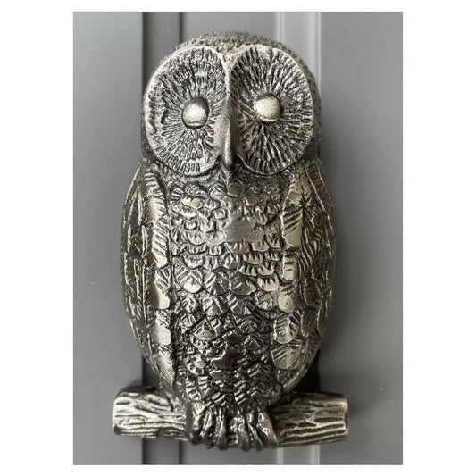 A silver gunmetal coloured owl shaped door knocker