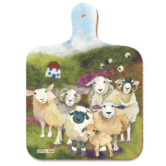 A paddle shaped chopping board with a design of sheep on a felted landscape background