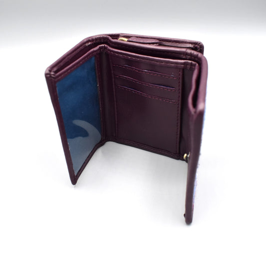 Inside of a tri-fold purple faux leather purse