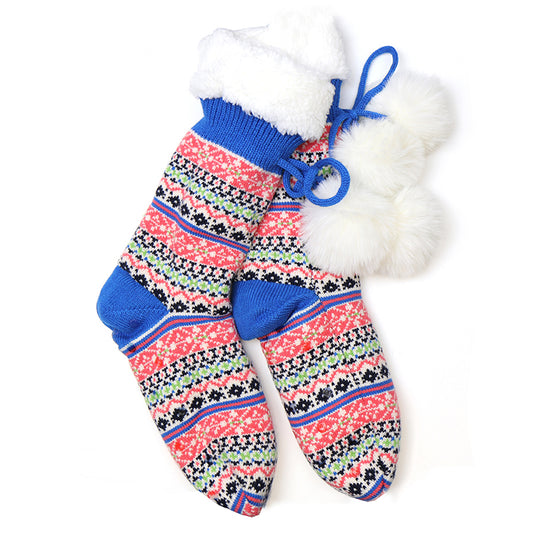 A pair of slipper socks with fluffy pompoms and patterned stripes