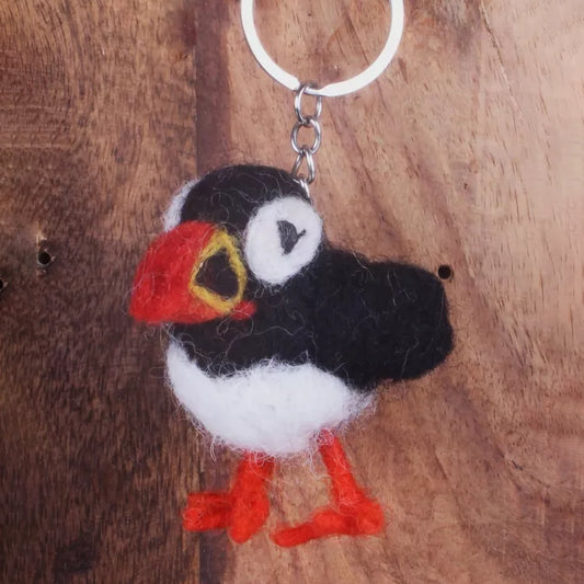 A felted keyring shaped like a puffin bird