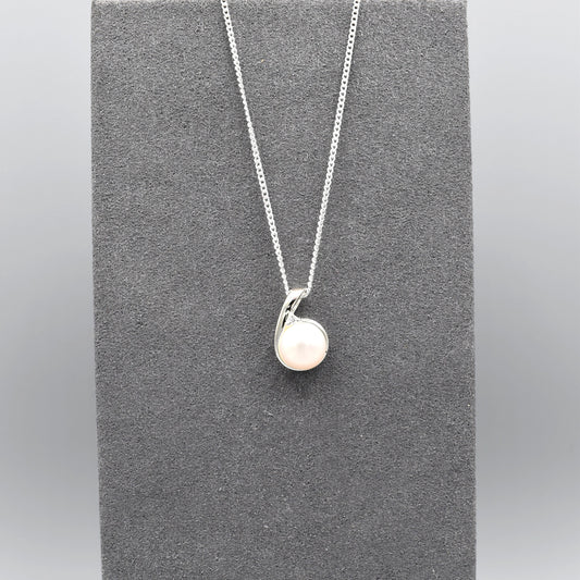 Small silver pendant with twist set with cubic zirconia stones and a round white fresh water pearl