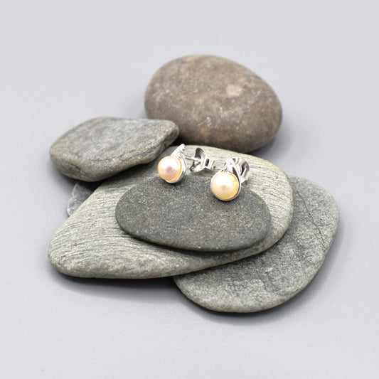 Small silver studs with twist set with cubic zirconia stones and a round white fresh water pearl