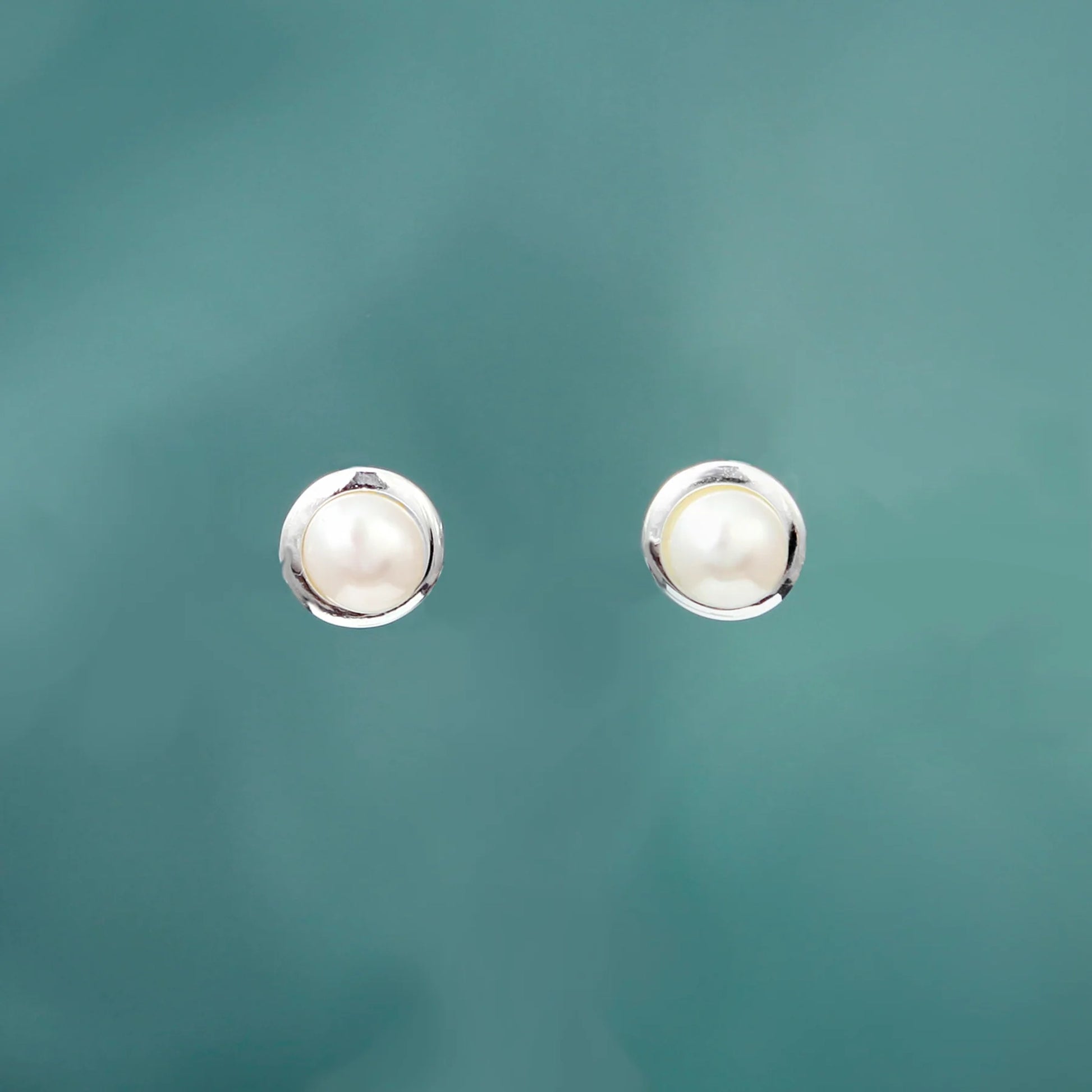 Silver round stud earrings with white freshwater pearls