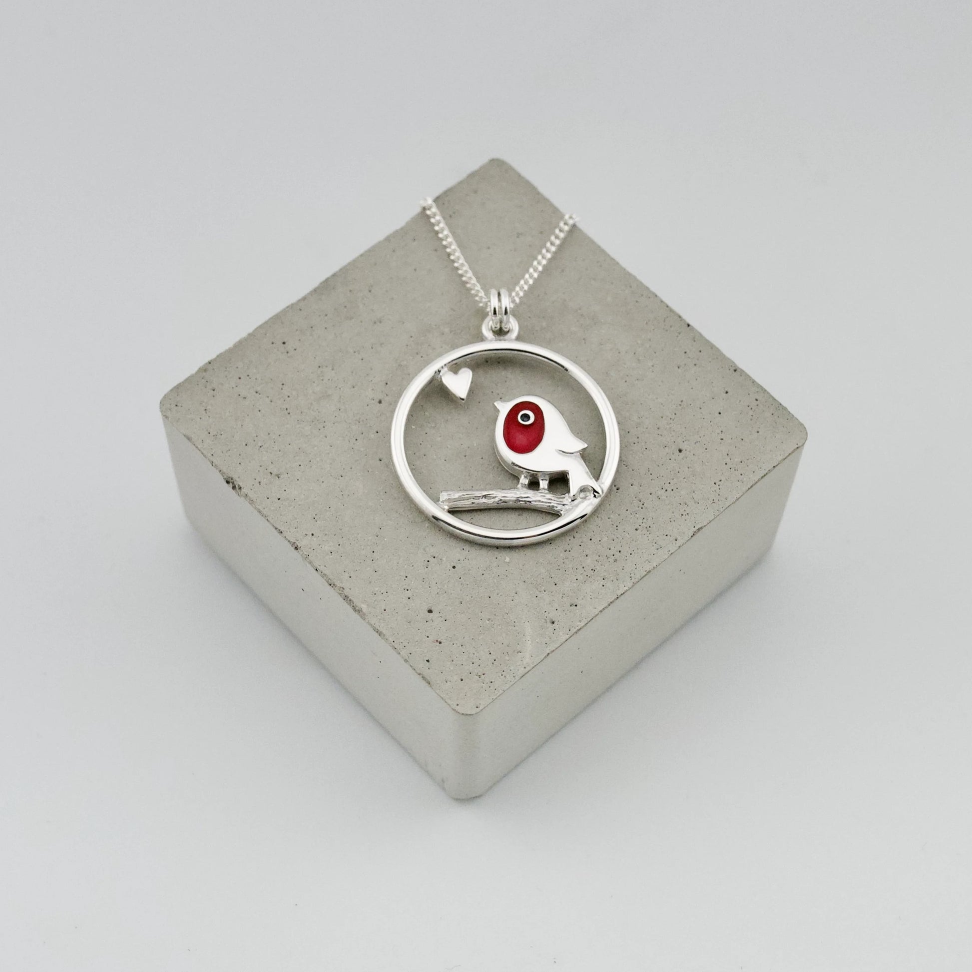 Silver pendant with framed red enamel robin and heart detail on silver chain