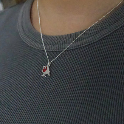 Model wearing a silver pendant with red enamel robin on silver chain