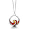 A silver pendant in the shape of an ocean wave coloured with red and yellow enamel