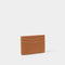 A faux brown leather card holder with contrasting light stitching