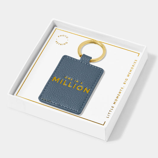 A faux leather navy keyring featuring the words One in a Million' in gold lettering