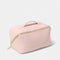 A pink makeup and wash bag with a gold zip in faux leather