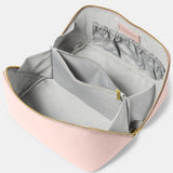 A pink makeup and wash bag with a gold zip in faux leather fully open and lined in grey