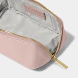 A pink makeup and wash bag with a gold zip in faux leather open