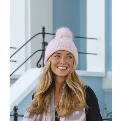 Light pink cable knitted pompom hat on model