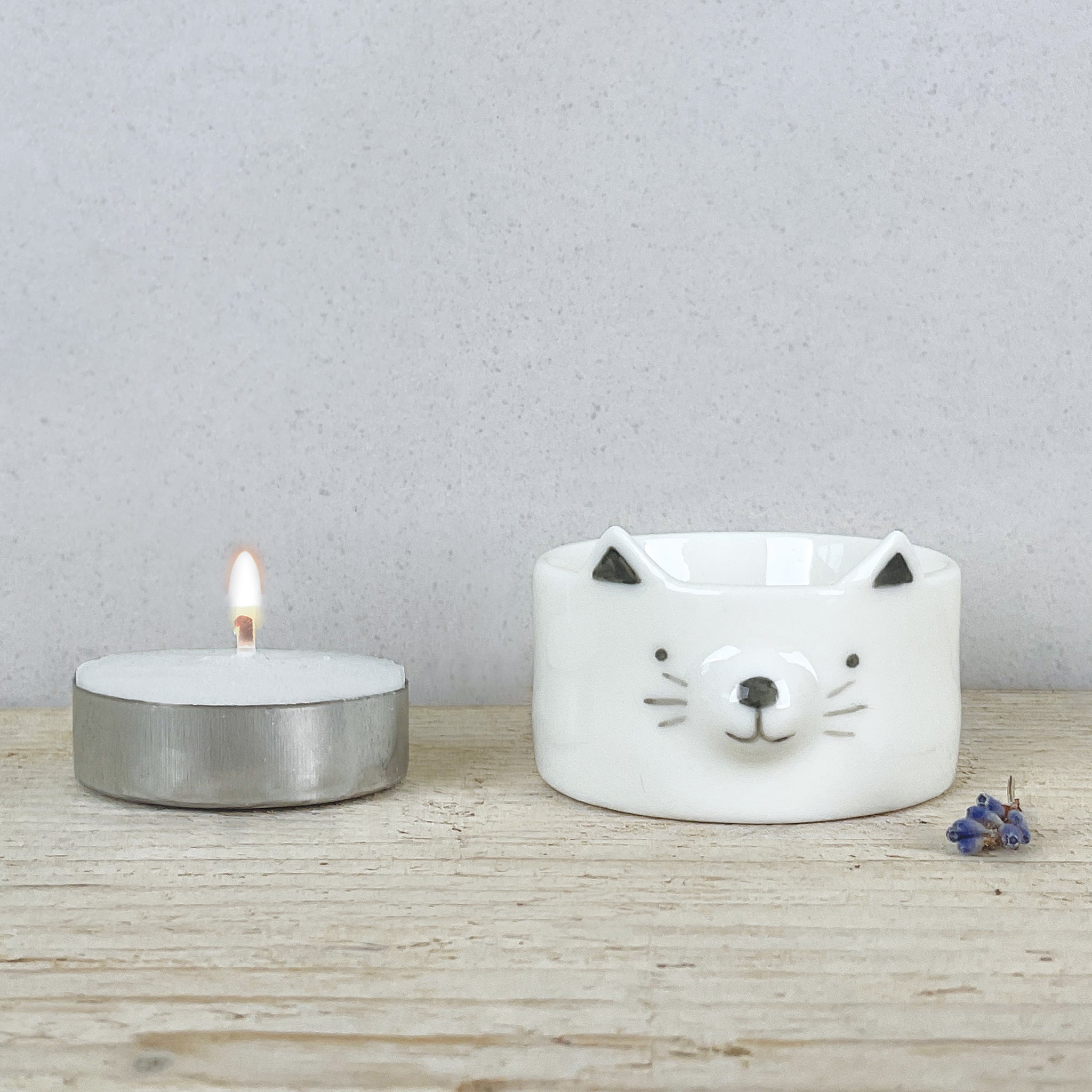 A white ceramic cat tealight holder 