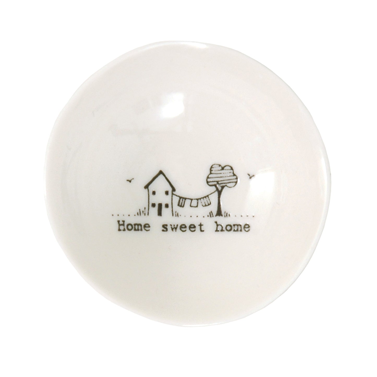 A white ceramic trinket bowl featuring a house & tree illustration and a quote